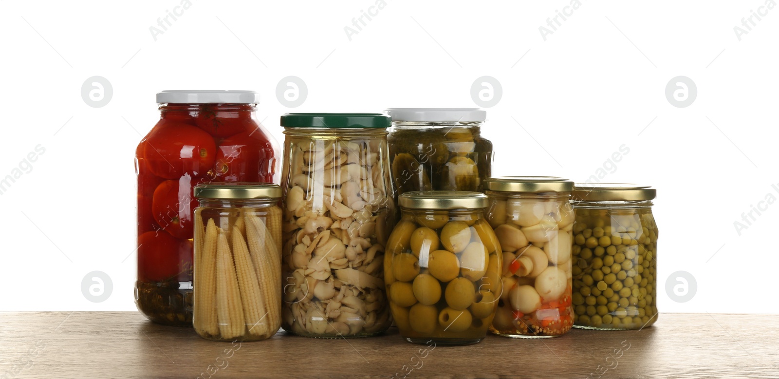 Photo of Jars of pickled vegetables on grey table