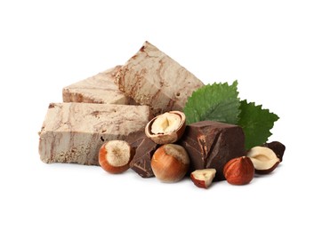 Image of Tasty halva, pieces of chocolate, hazelnuts and green leaves isolated on white