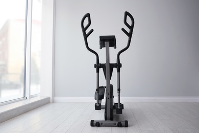 Photo of Elliptical machine cross trainer near window indoors