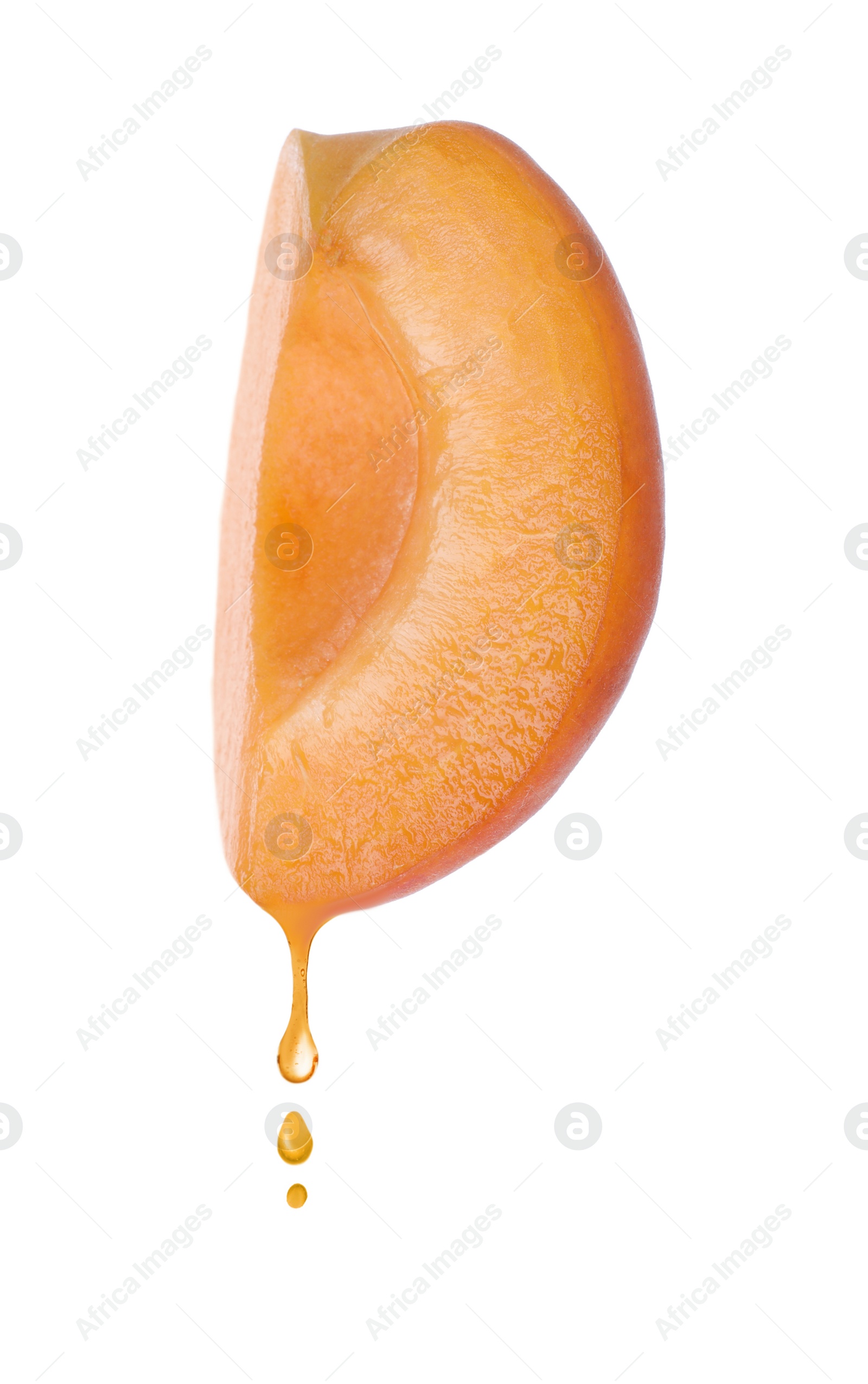 Image of Apricot oil dripping from fresh cut fruit half on white background