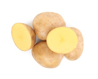 Whole and cut fresh potatoes on white background, top view