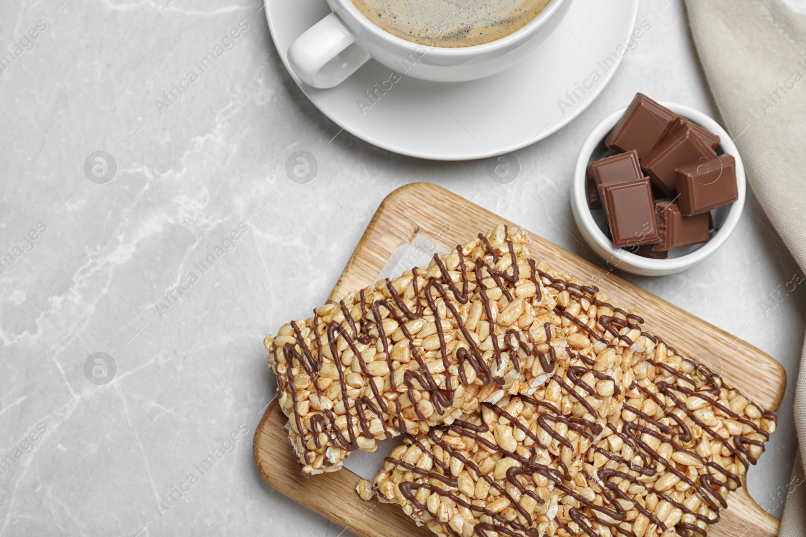 Photo of Delicious rice crispy treats on light grey table, flat lay. Space for text