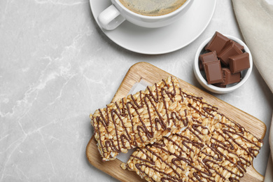 Photo of Delicious rice crispy treats on light grey table, flat lay. Space for text