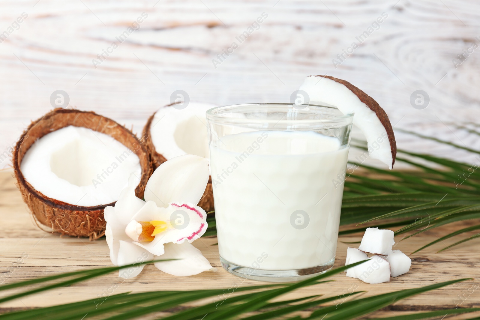 Photo of Glass of coconut milk on wooden background