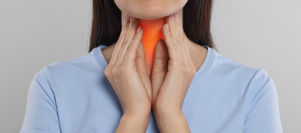 Endocrine system. Woman doing thyroid self examination on light grey background, closeup. Banner design