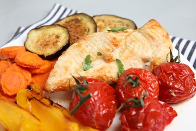 Photo of Delicious cooked chicken and vegetables on plate, closeup. Healthy meals from air fryer