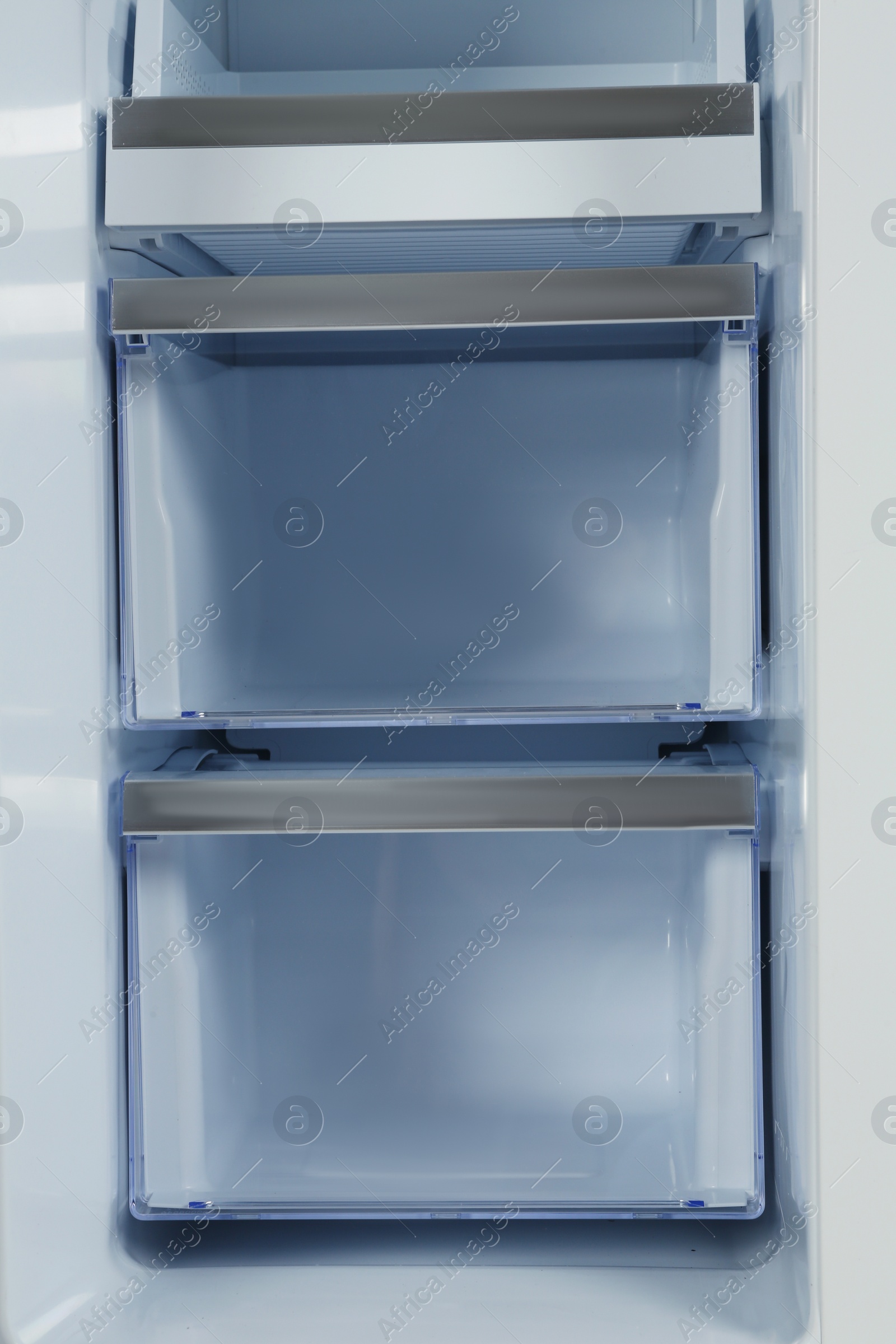 Photo of Shelves of empty modern refrigerator, closeup view