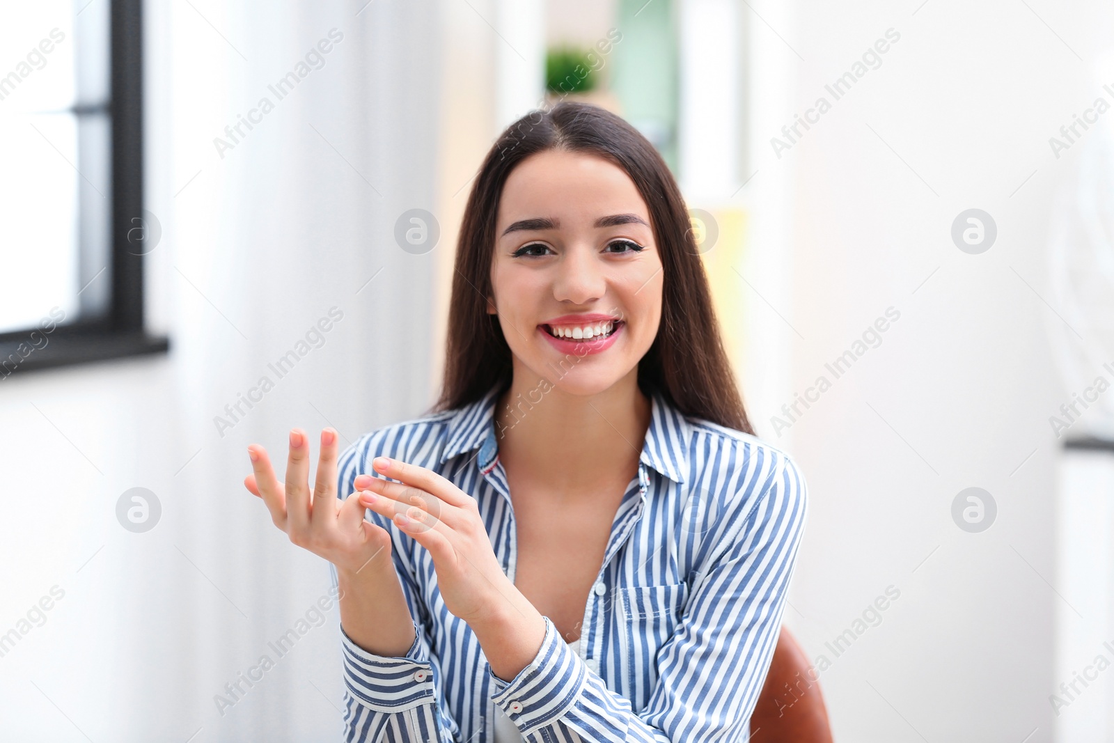 Photo of Beautiful woman using video chat for conversation indoors