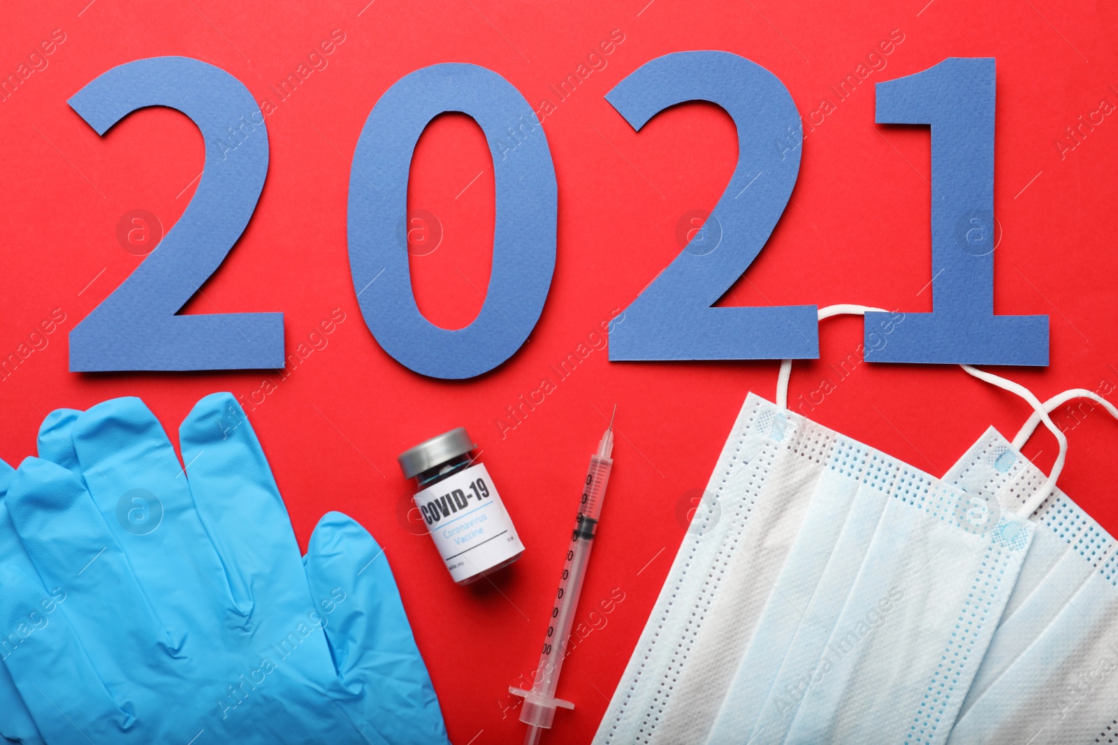 Photo of Flat lay composition with coronavirus vaccine and number 2021 on red background