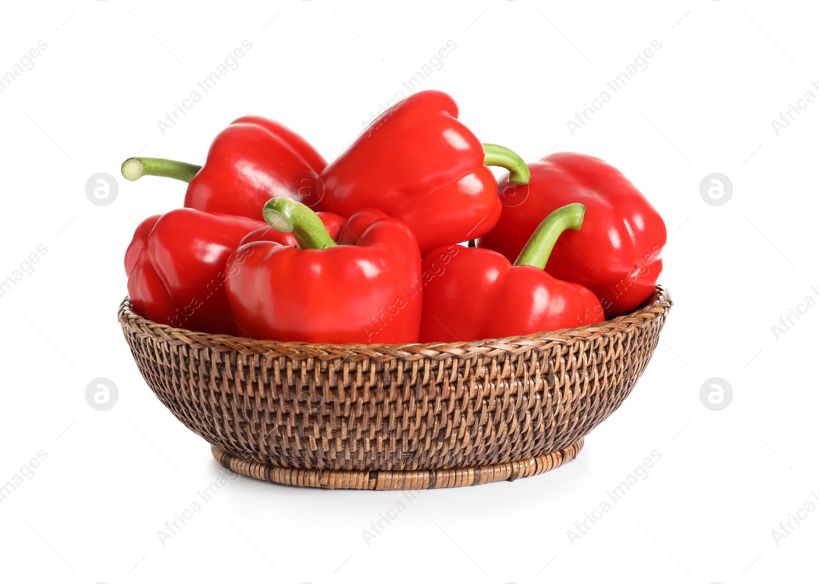 Photo of Wicker bowl with tasty bell peppers on white background