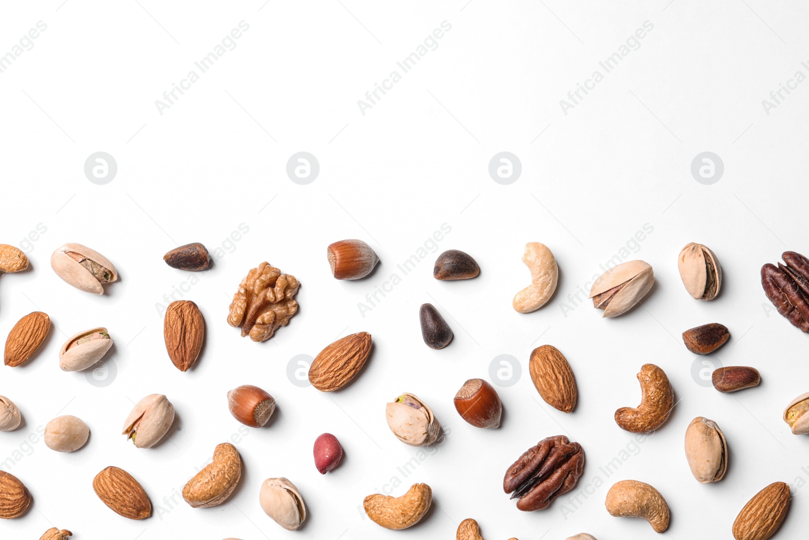 Photo of Composition with organic mixed nuts on white background, top view. Space for text