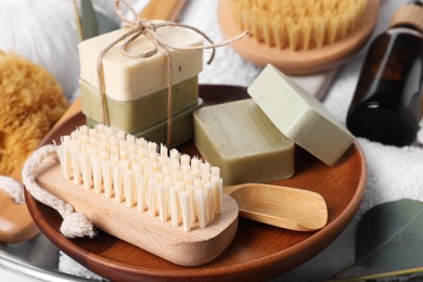 Photo of Spa composition with brush and soap bars, closeup