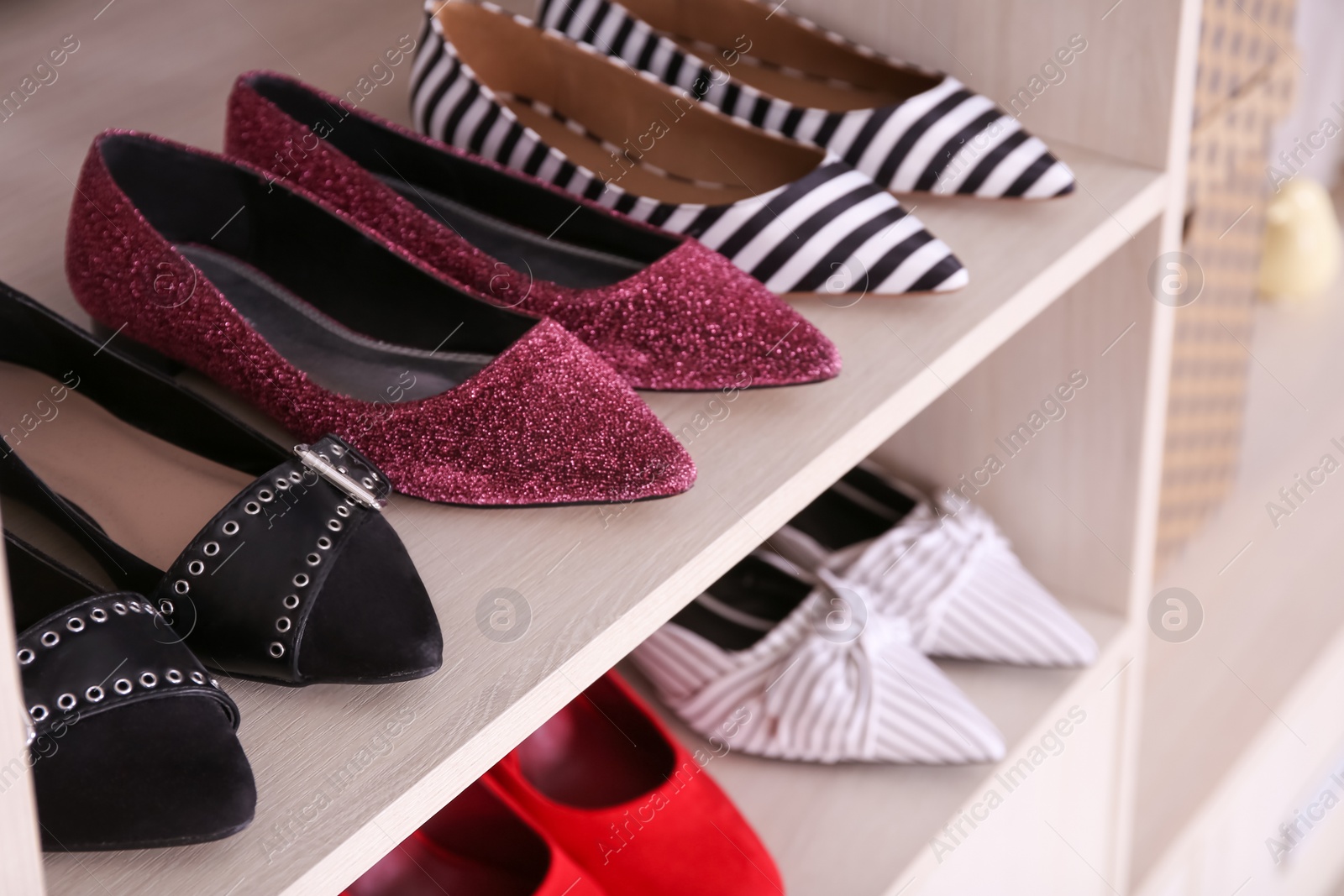 Photo of Wardrobe shelves with different stylish shoes