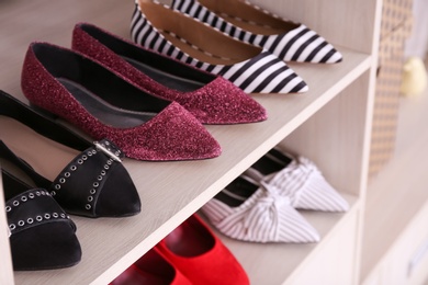 Wardrobe shelves with different stylish shoes