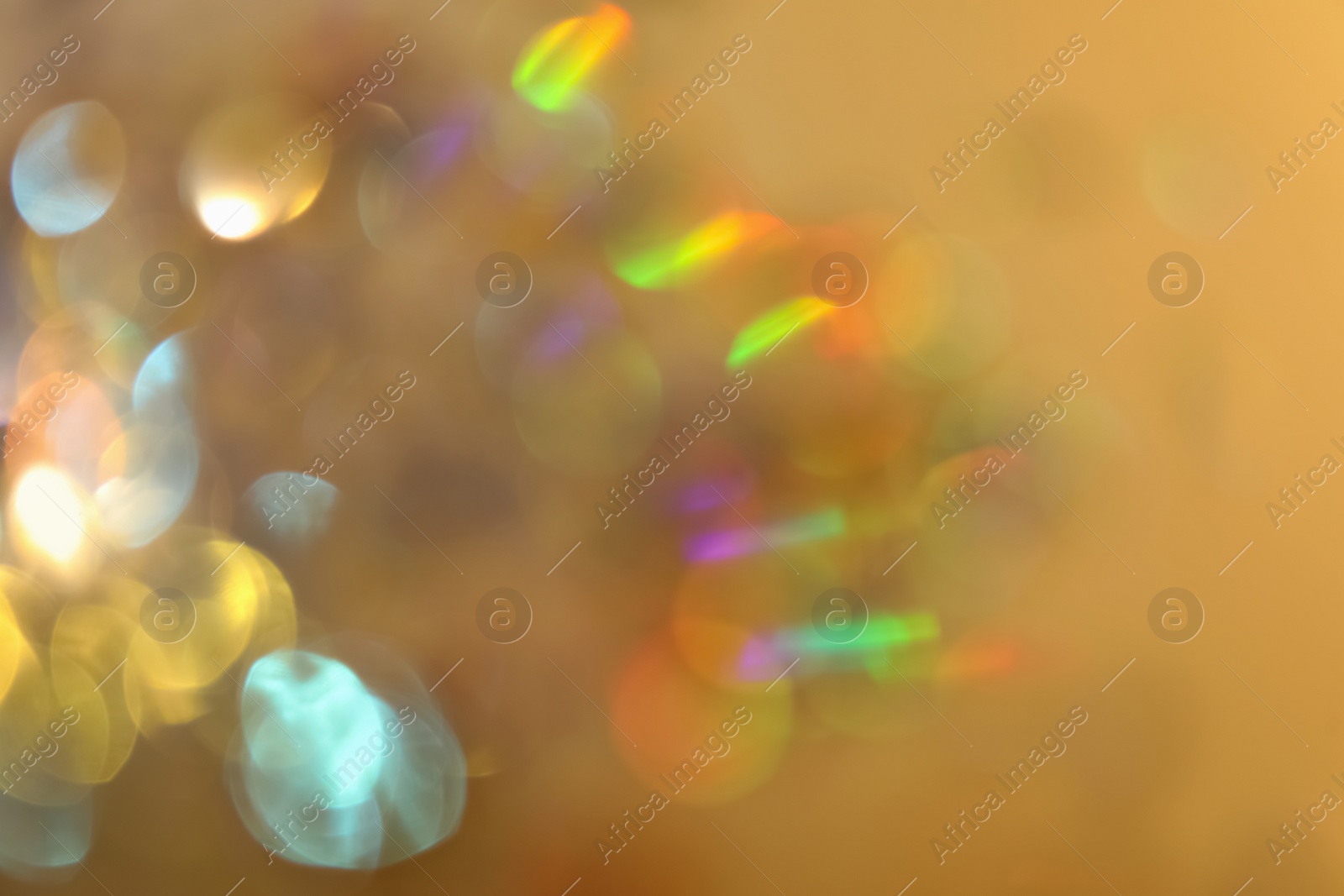 Photo of Blurred view of shiny lights on beige background. Bokeh effect