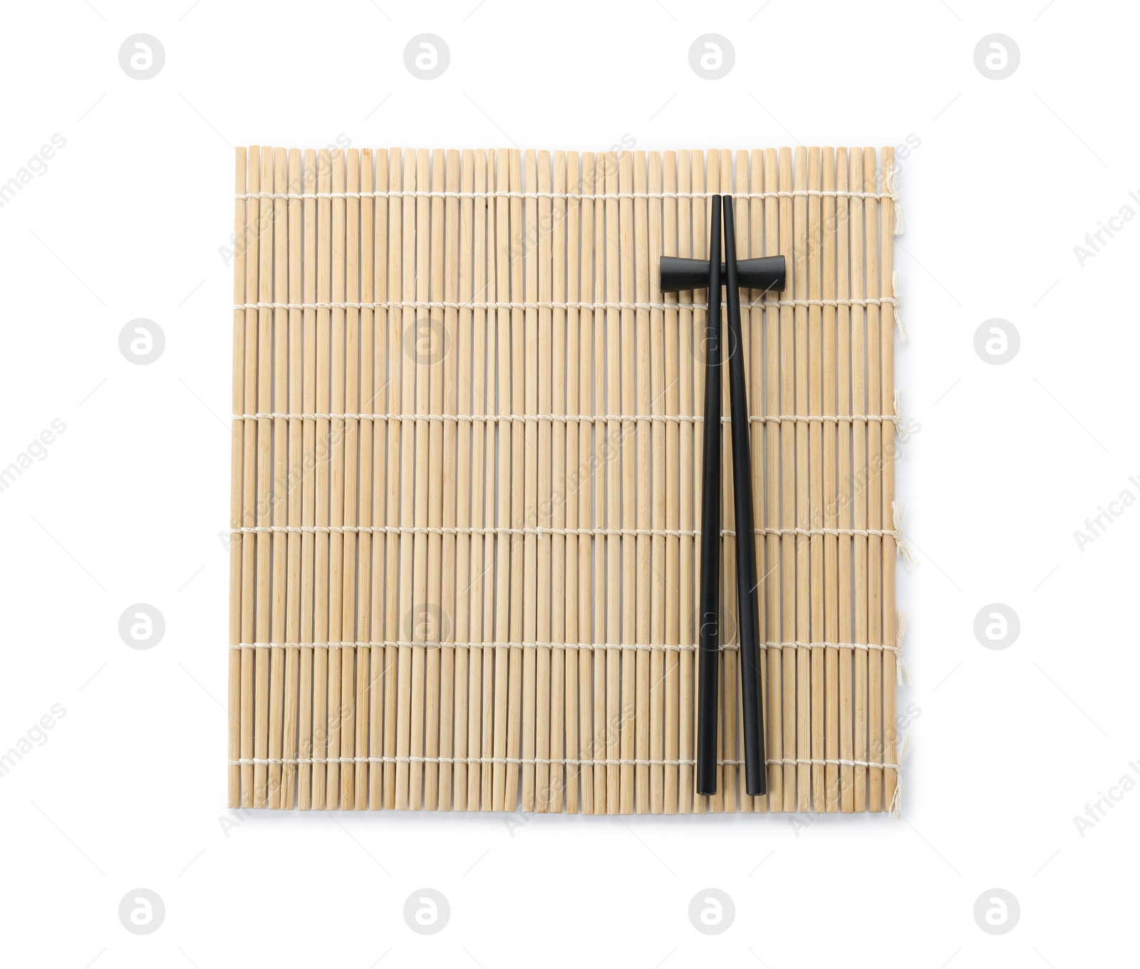 Photo of Bamboo mat with pair of black chopsticks and rest isolated on white, top view