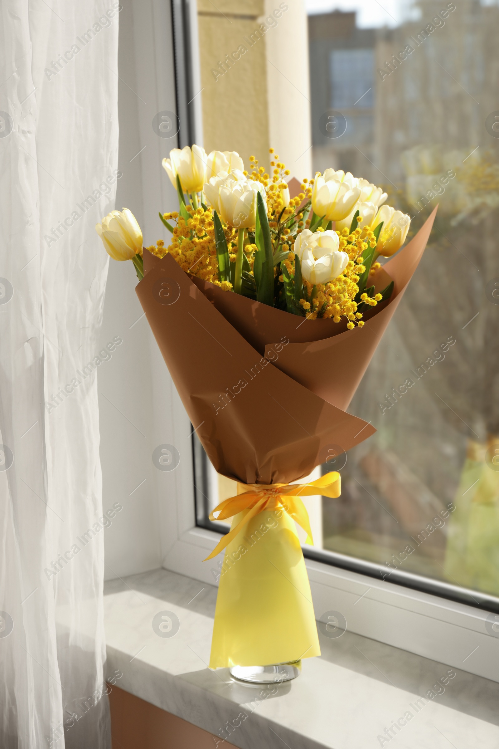 Photo of Bouquet of beautiful spring flowers on windowsill indoors