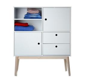 Photo of Stylish dresser with clothes on white background. Furniture for wardrobe room