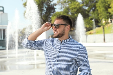 Photo of Portrait of handsome young man on street