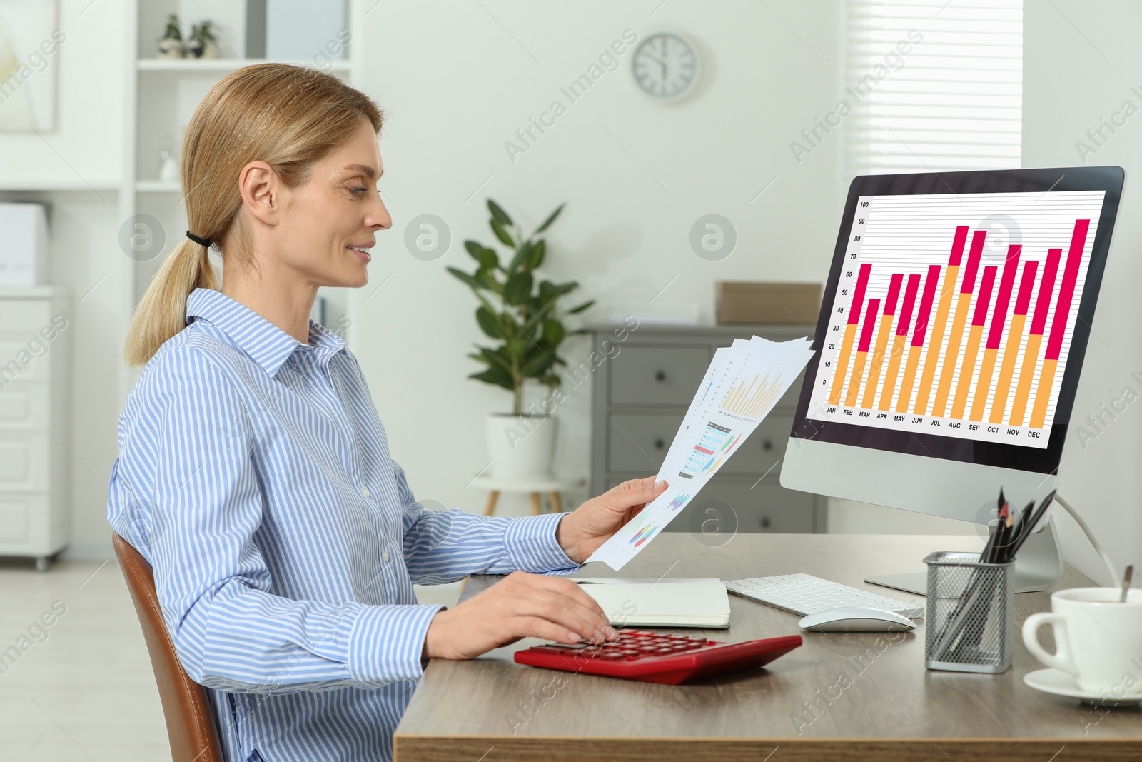 Photo of Professional accountant working at wooden desk in office