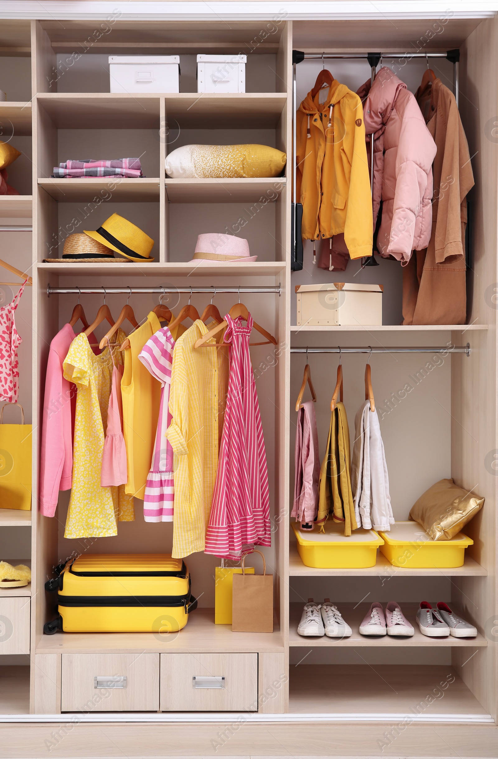 Photo of Stylish clothes, shoes and accessories in large wardrobe closet