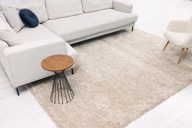 Fluffy carpet and stylish furniture on floor indoors