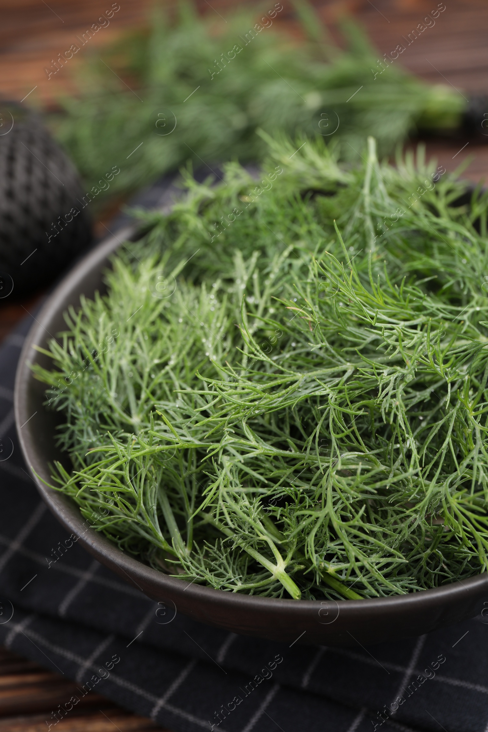 Photo of Bowl of fresh dill on table, closeup view