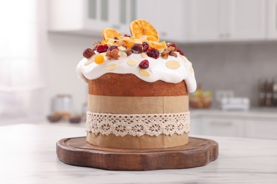 Delicious Easter cake with dried fruits on white marble table in kitchen