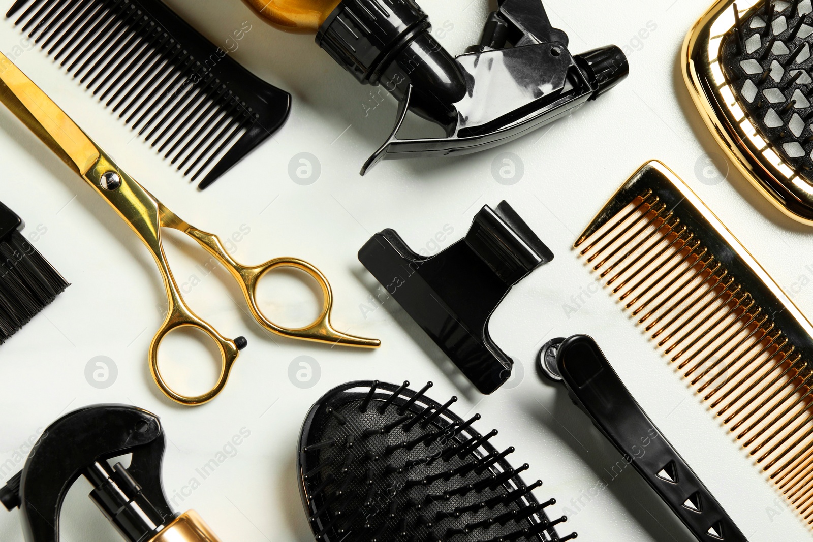 Photo of Hairdressing tools on white table, flat lay