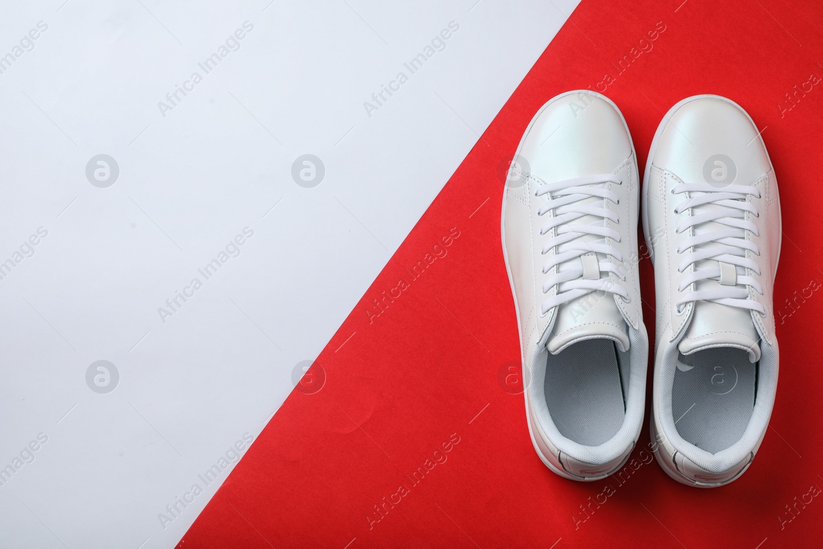 Photo of Pair of sneakers on color background, flat lay. Space for text