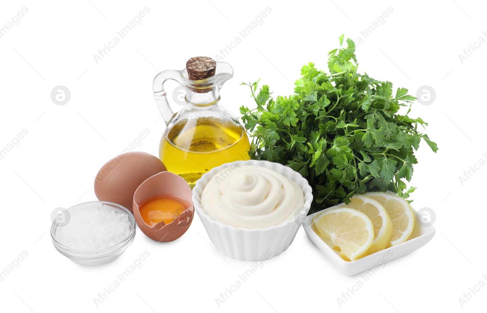 Photo of Fresh mayonnaise sauce in bowl and ingredients on white background