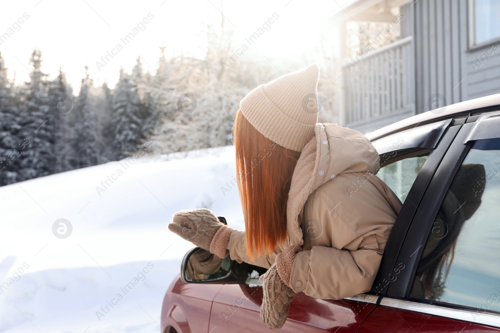 Photo of Woman looking out of car window, space for text. Winter vacation