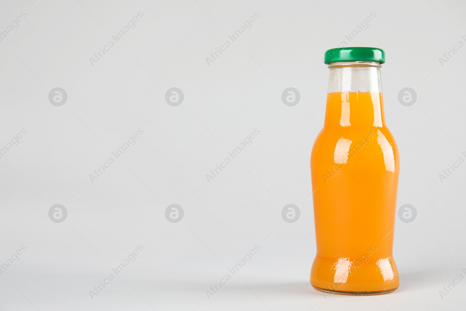 Photo of One bottle with tasty drink on color background. Space for text