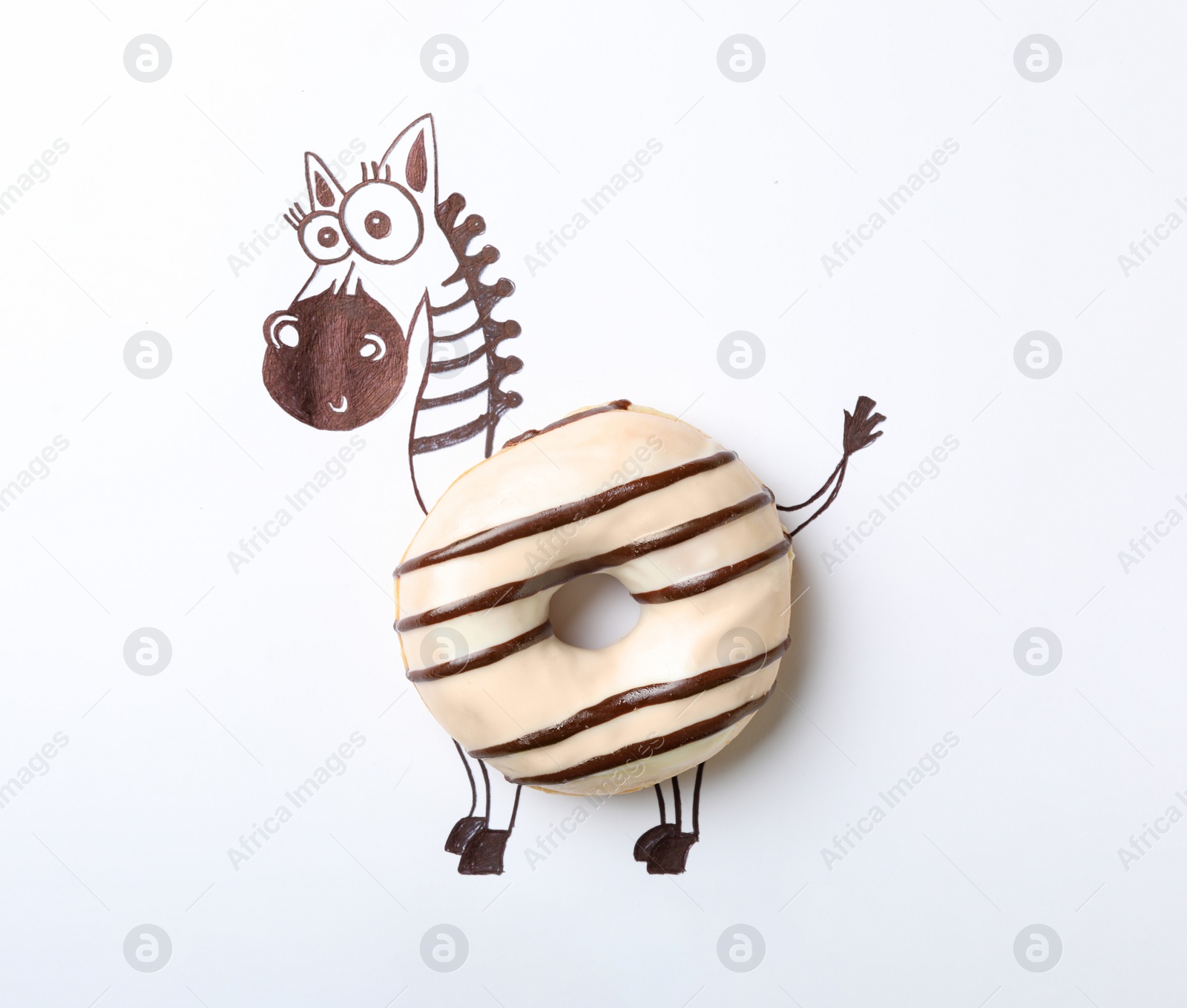 Photo of Funny zebra made with donut on white background, top view