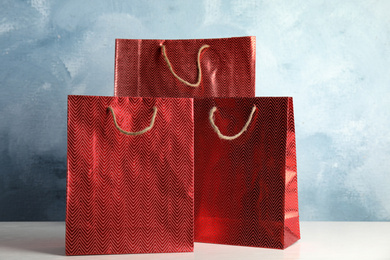 Photo of Red shopping paper bags on white table