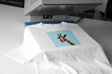 Image of Custom t-shirt. Using heat press to print image of giraffe blowing bubble gum