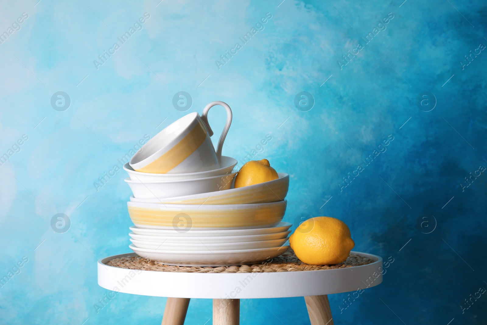 Photo of Composition with dinnerware on table against color background. Interior element