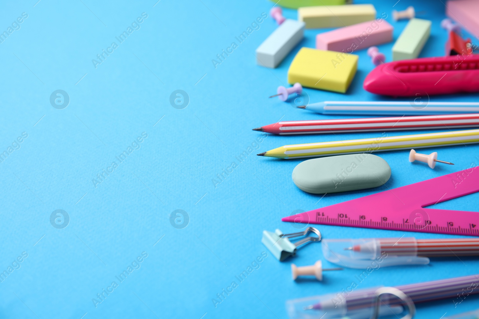 Photo of Different school stationery on light blue background, space for text. Back to school