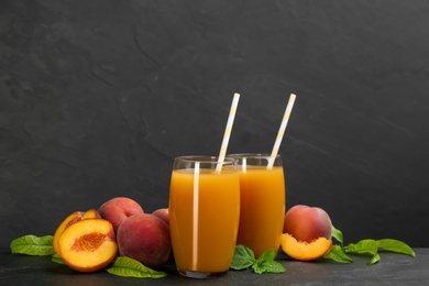 Photo of Natural freshly made peach juice on grey table