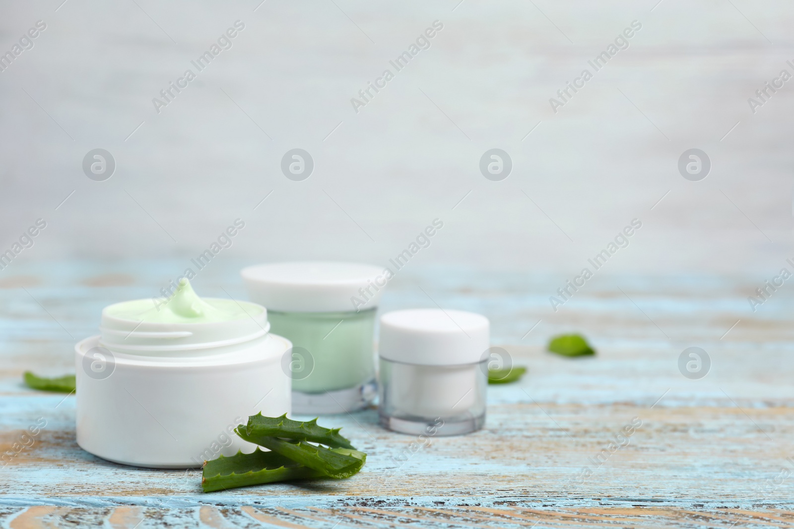 Photo of Composition with body cream in jars on light background