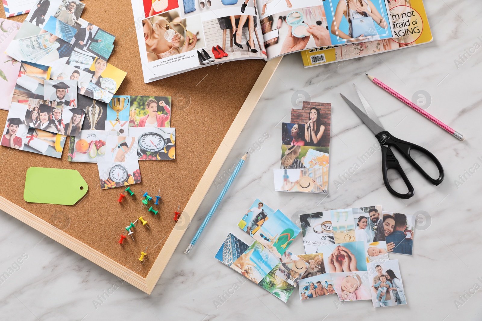 Photo of Flat lay composition with different photos, magazines and stationery on white marble background. Creating vision board