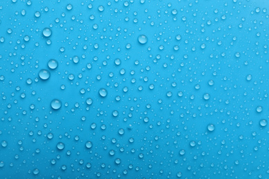 Photo of Water drops on light blue background, top view