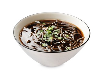 Photo of Tasty soup with buckwheat noodles (soba), onion and sesame in bowl isolated on white