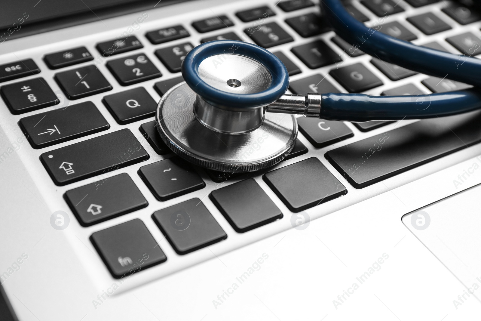 Photo of Stethoscope on laptop, closeup. Concept of technical support