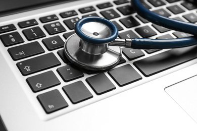 Stethoscope on laptop, closeup. Concept of technical support
