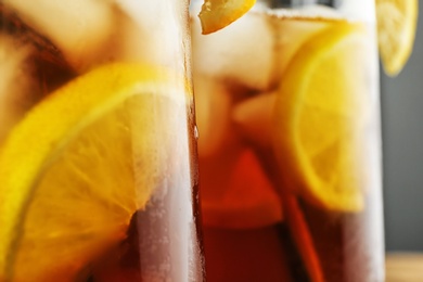 Photo of Glassware with delicious refreshing iced tea, closeup