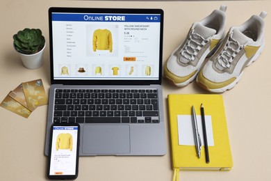 Photo of Online shopping. Composition with laptop on beige background