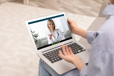 Online medical consultation. Woman having video chat with doctor via laptop at home, closeup