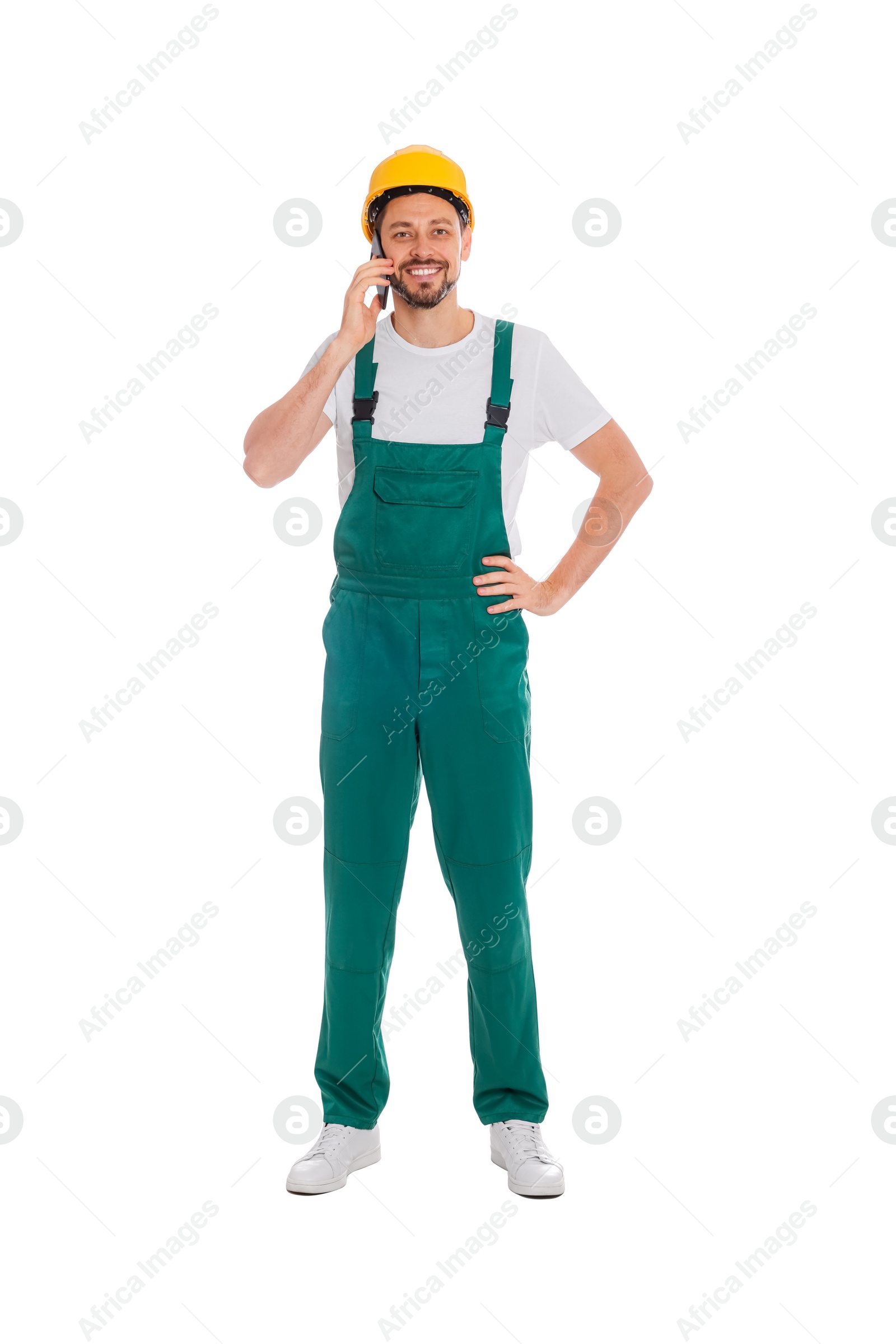 Photo of Professional repairman in uniform talking on phone against white background