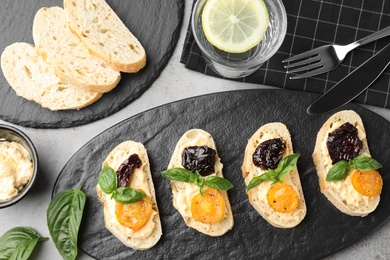 Tasty fresh tomato bruschettas on grey table, flat lay